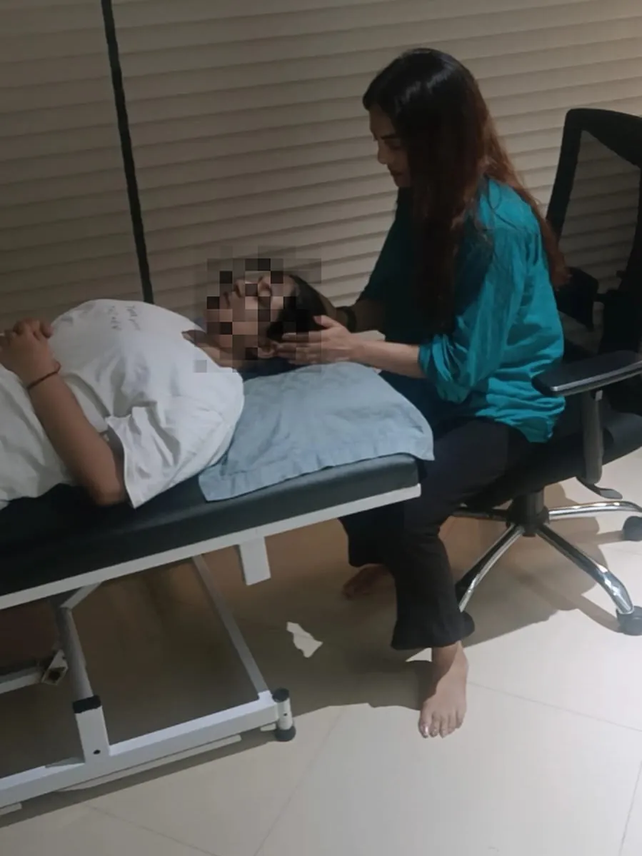 A calm one-to-one hypnotherapy session in progress, with the client's identity protected