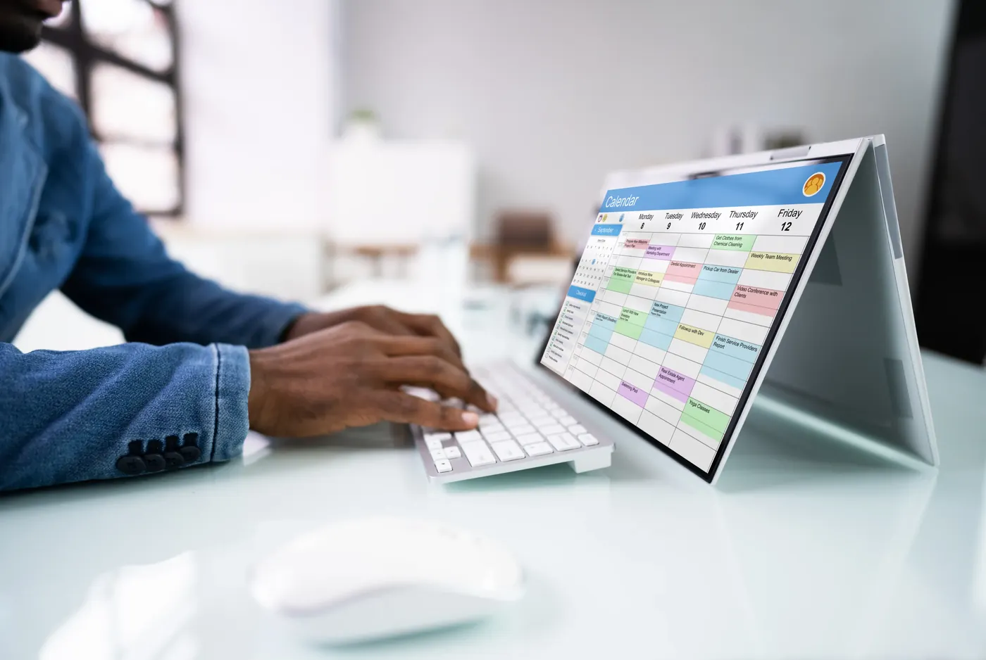 A person reviewing a calendar on a laptop while planning ahead