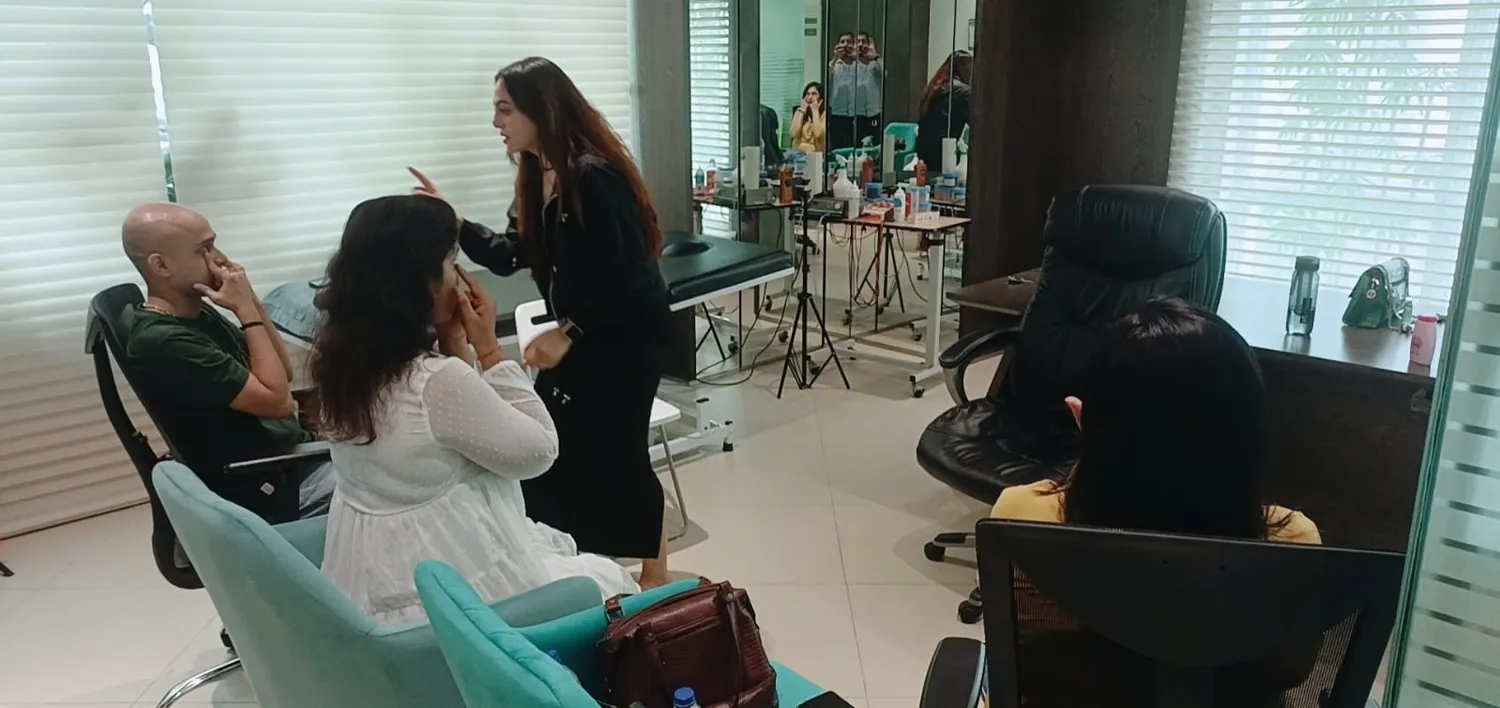 Vibha Jain explaining a relaxation technique to a small group in a practice room